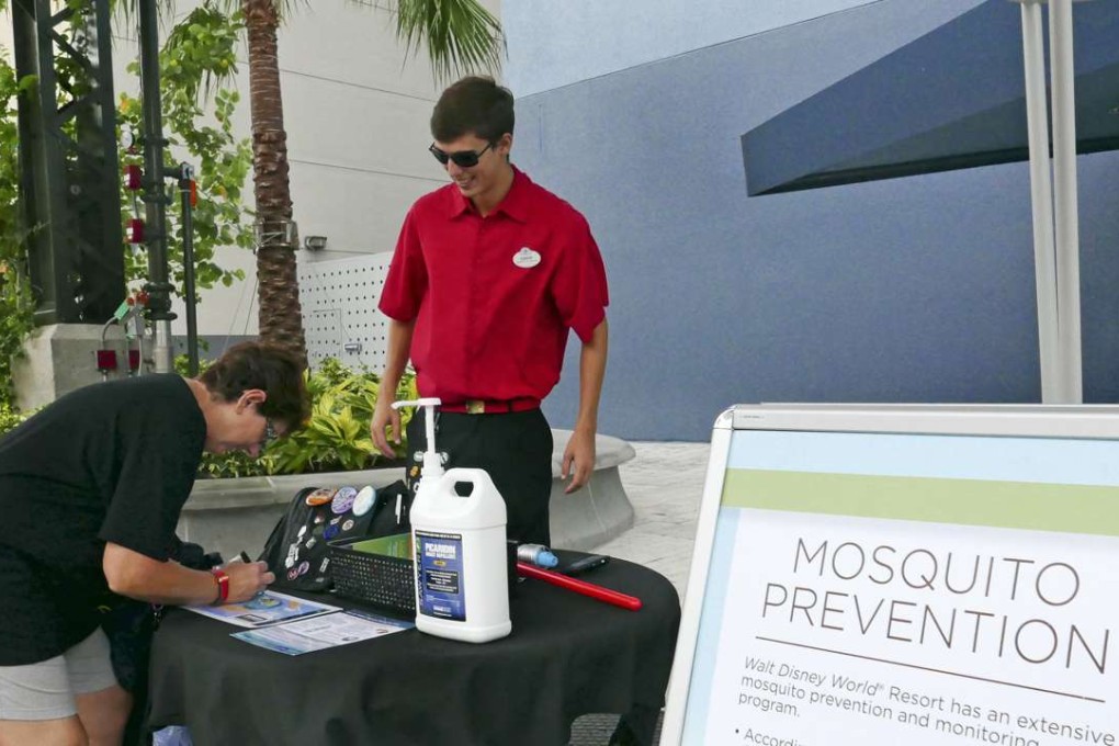 IA tourist stops by a location giving out free mosquito repellant at Disney Springs in Lake Buena Vista, Florida. Photo: AP