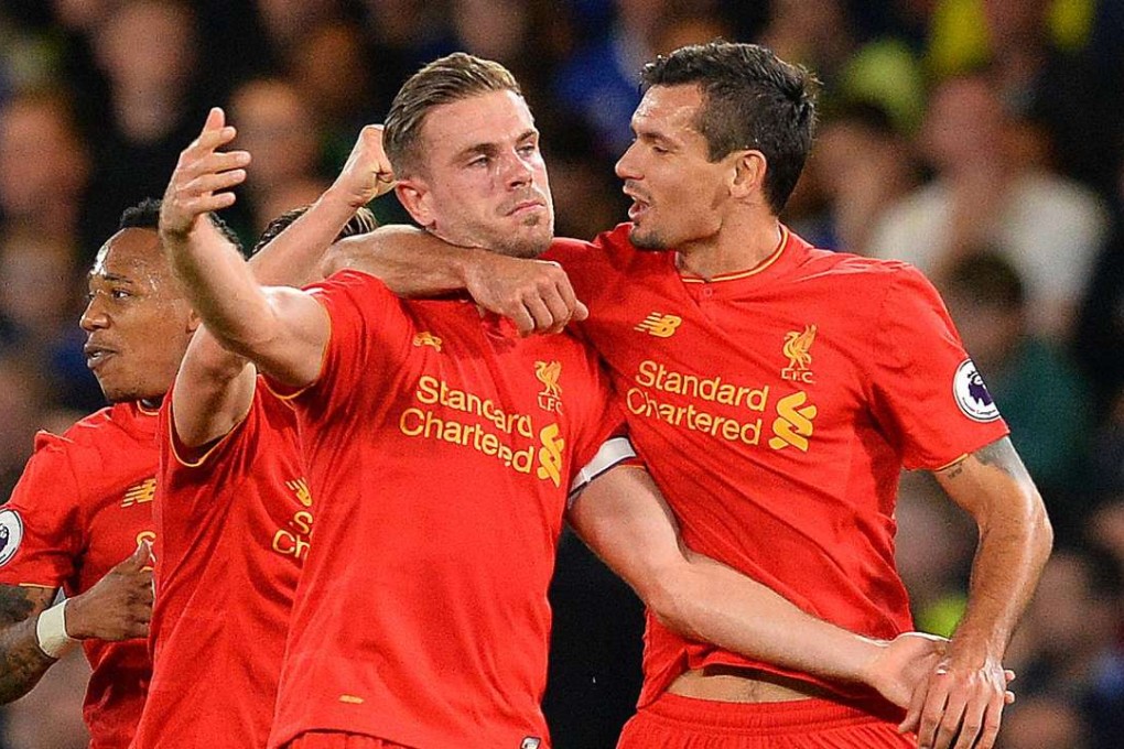 Liverpool's Jordan Henderson celebrates with Dejan Lovren (R) after scoring his team's second goal. Photo: AFP