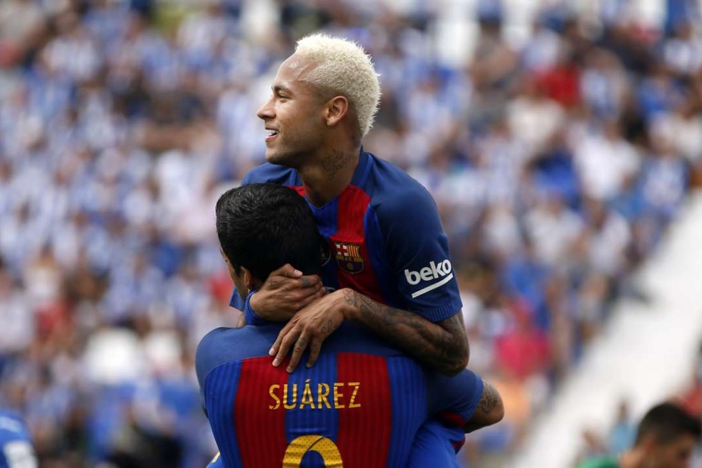 Barcelona's Neymar, top, celebrates with teammate Luis Suarez after scoring during the Spanish La Liga soccer match between Leganes and Barcelona at the Butarque stadium in Madrid, Spain, Saturday, Sept. 17, 2016. (AP Photo/Paul White)