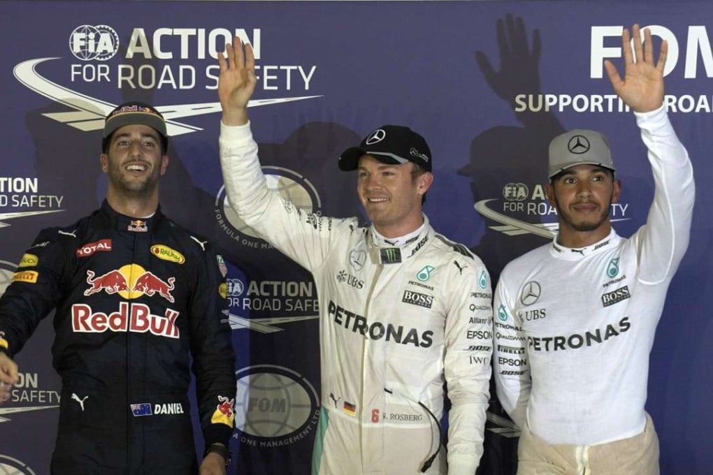Mercedes drivers Nico Rosberg (C) and Lewis Hamilton (R) celebrate after qualifying with Red Bull’s Daniel Ricciardo who will share pole position with the German. Photo: Xinhua