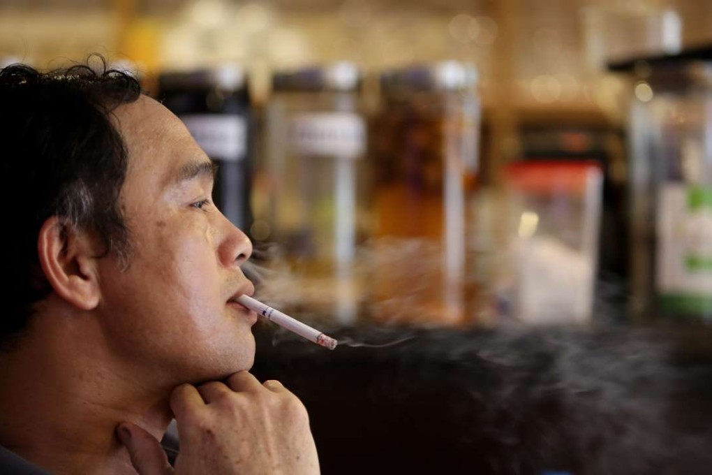 A man smokes a cigarette in a cafe in Hanoi, Vietnam on September 9, 2016. Photo: EPA