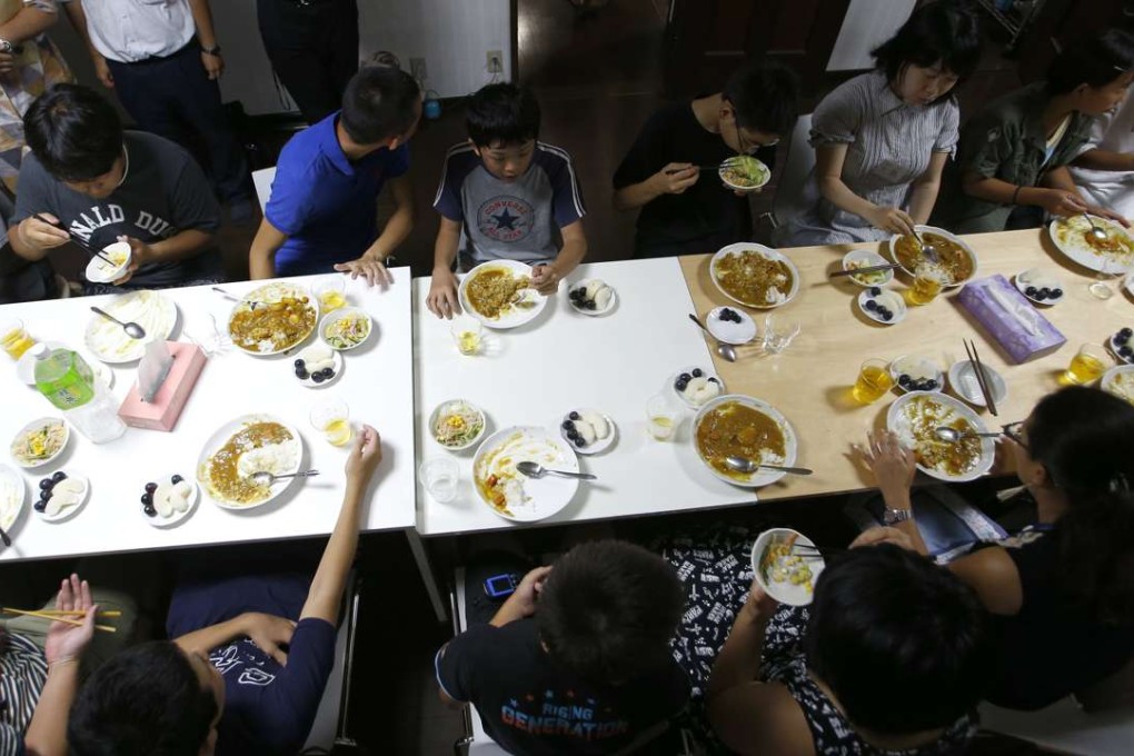 Visitors and volunteers have a meal at a ‘children’s cafeterias’, in Tokyo. Photo: AP