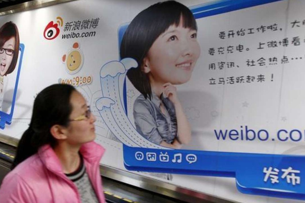 A woman looks at a Weibo advertisement inside a subway station in Beijing. Photo: SCMP Pictures