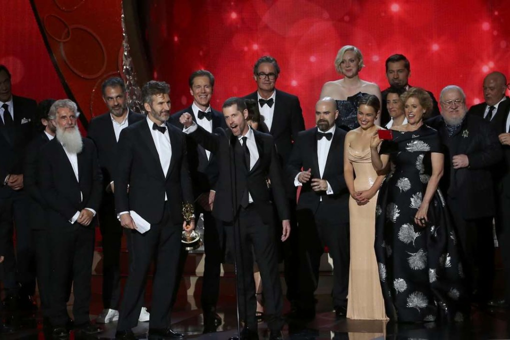 Executive producers David Benioff, center left, and DB Weiss accept the Emmy award for Oustanding Drama Series for Game of Thrones with their cast and crew in Los Angeles on Sunday. Photo: Reuters