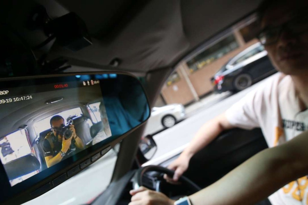 Taxi driver Leung Wing-hong shows the on-board surveillance cameras designed to raise service quality. Photo: David Wong