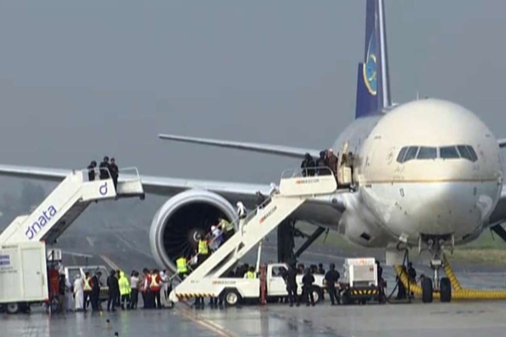 People disembark from a Saudi Arabian Airlines plane from Jeddah as it is parked at the airport in Manila. Photo: AP