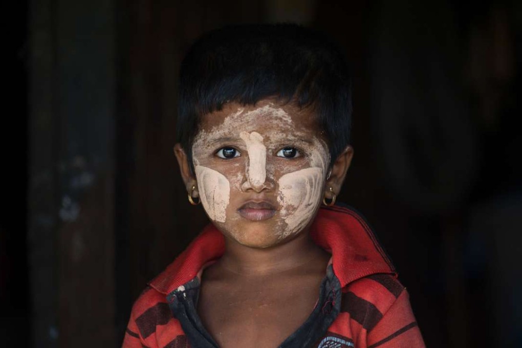A minority Muslim Rohingya child wearing traditional facial paste is seen in a shelter at the Thet Kal Pyin displacement camp in Sittwe. Photo: AFP