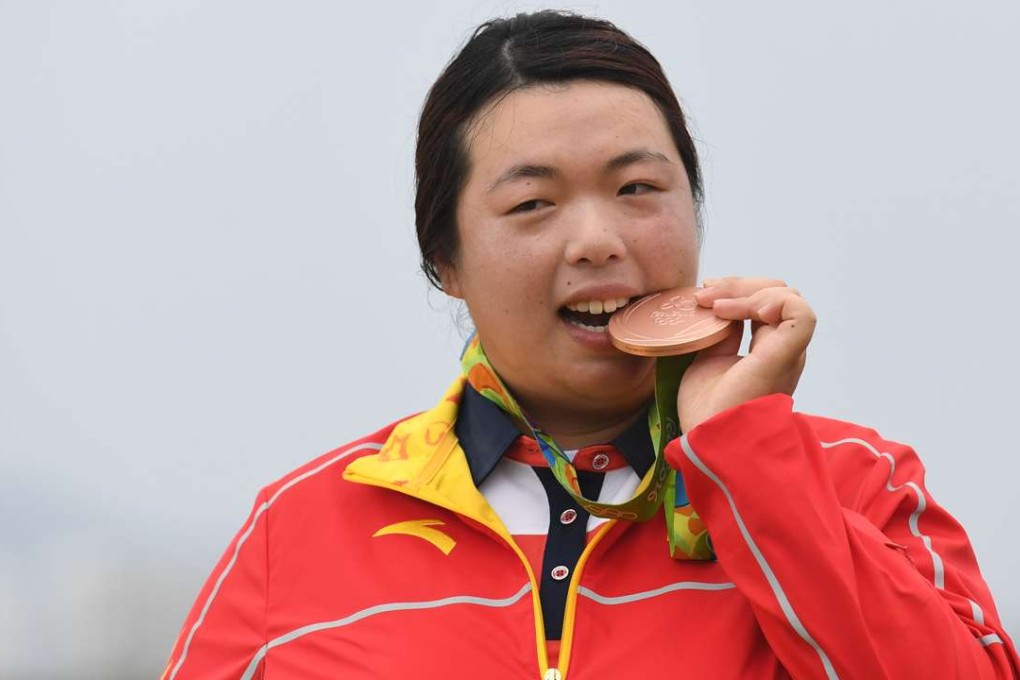 China's Feng Shanshan poses with her bronze medal at the Olympic Games. Photo: AFP