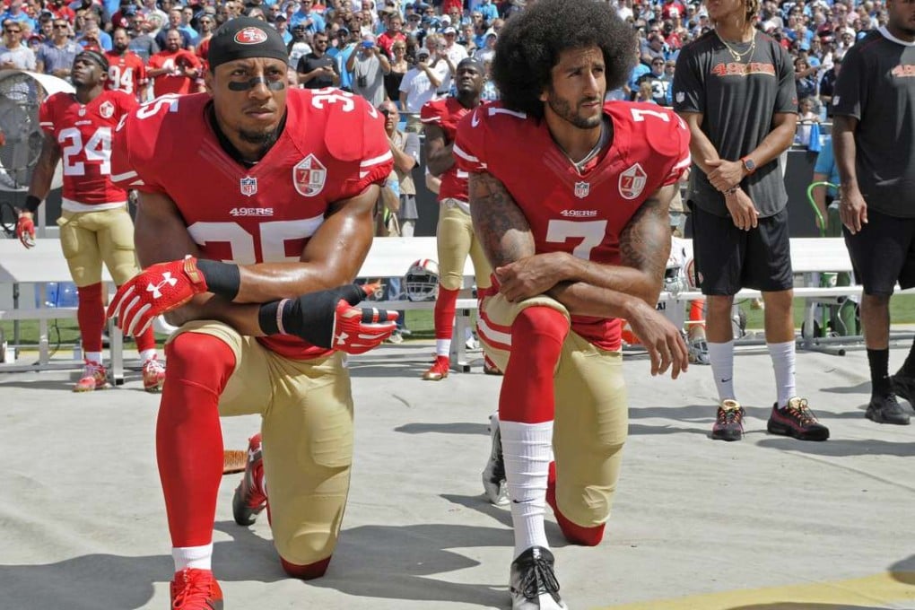 The San Francisco 49ers' Colin Kaepernick (right) and Eric Reid kneel during the playing of the US national anthem before the game against the Carolina Panthers in Charlotte, North Carolina. Photo: AP