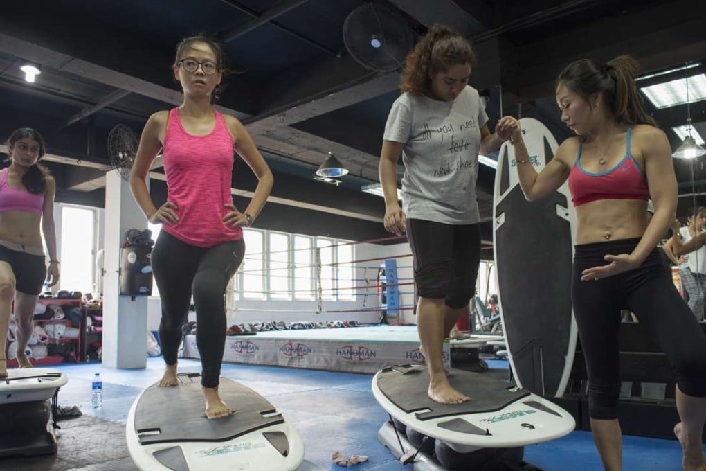 Cherilyn Chow (right), managing director and instructor at Surfset Fitness Hong Kong, puts Post writer Elaine Yau (left) and others through their paces. Photos: Antony Dickson