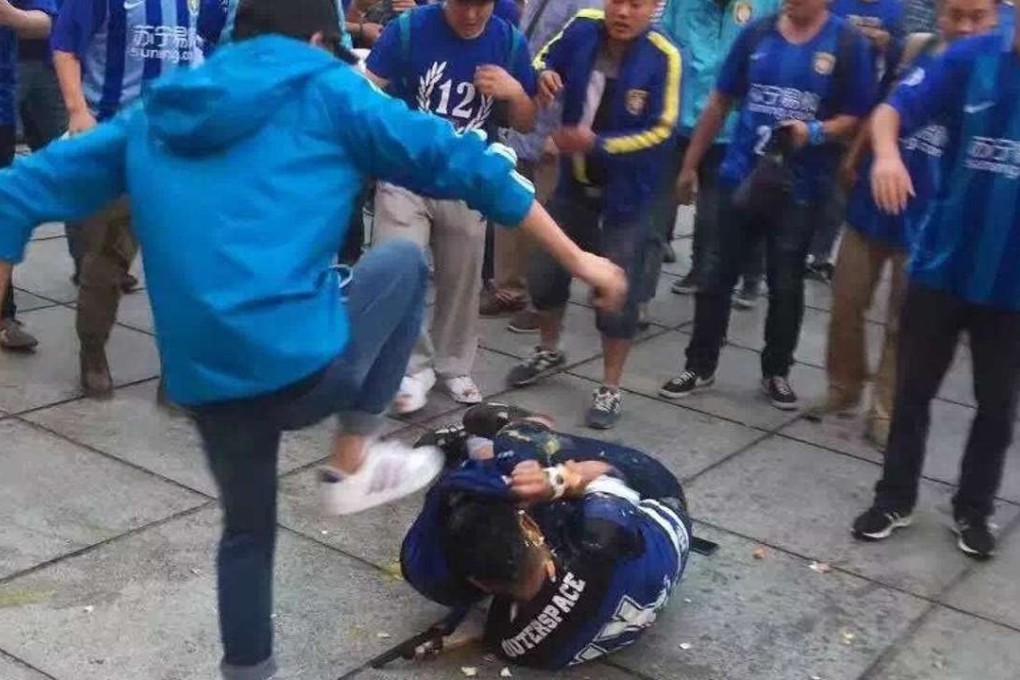 Jiangsu fans attack a Shanghai supporter