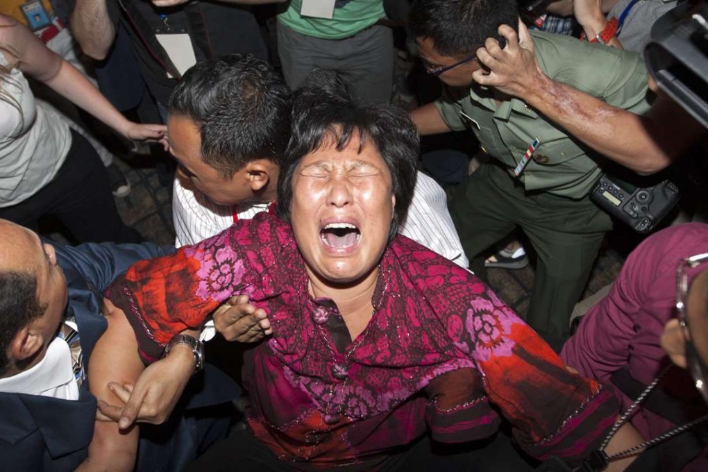 A family member of a Chinese passenger on Malaysia Airlines flight MH370 breaks down as she speaks to the media at Kuala Lumpur International Airport on March 19, 2014. Photo: EPA