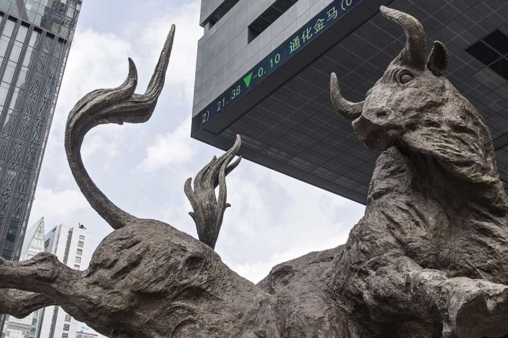 A sculpture of bulls near the electronic ticker board displaying stock prices at the Shenzhen Stock Exchange. Photo: Bloomberg