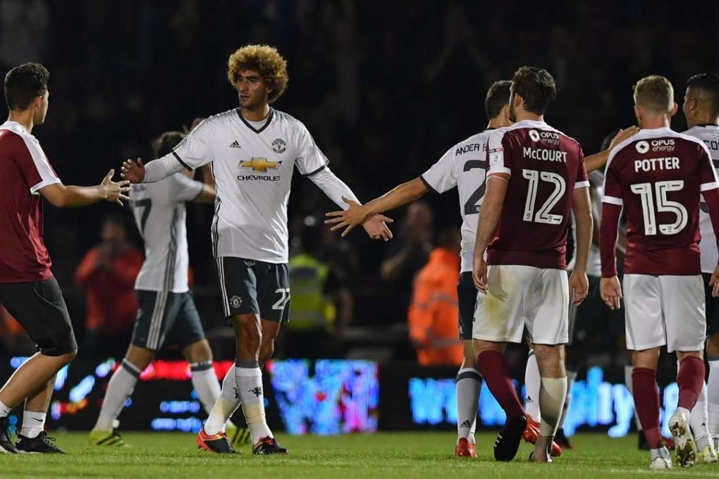 Manchester United emerged from a tough test at Northampton Town. They will meet Manchester City in round four. Photo: AFP