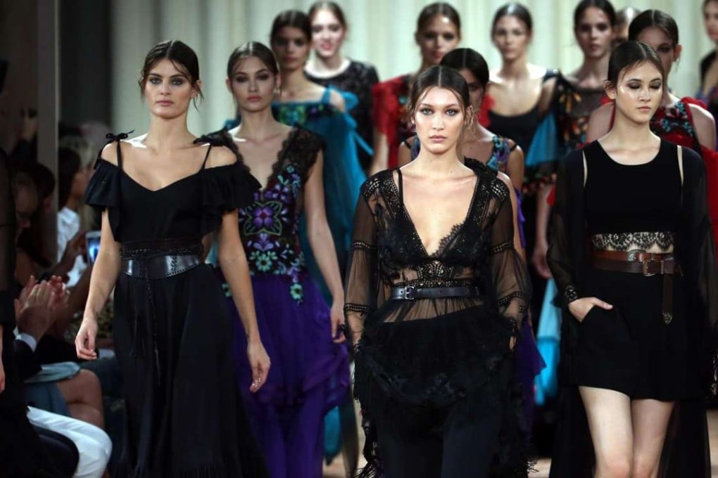 US model Bella Hadid (C) presents a creation from the Spring/Summer 2017 collection by Italian designer Alberta Ferretti during the Milan Fashion Week. Photo: EPA