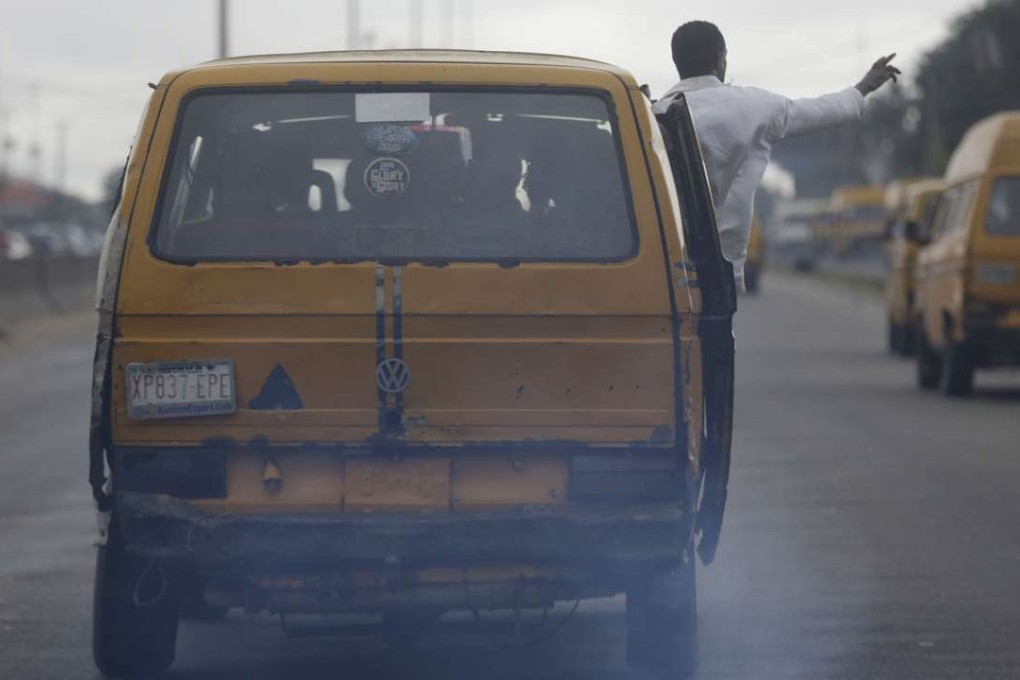 Fumes pour out of commercial buses operating on a Lagos street. The city successfully curbed the spread of Ebola through a vigorous public health effort and social mobilisation. Photo: AP