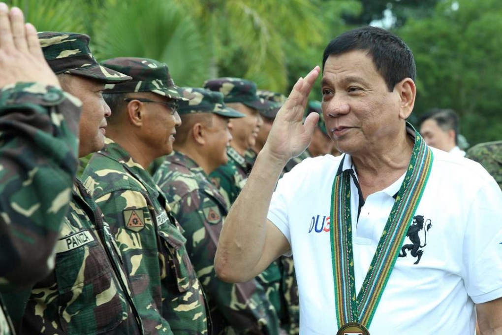 Philippine President Rodrigo Duterte saluting troops during a visit to a military camp in Compostela Valley. Photo: EPA