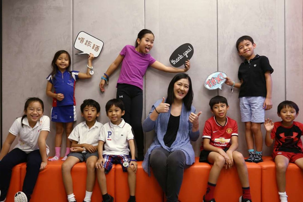Christine Ma-Lau, principal of JEMS Learning House for character education, and students celebrate Character Day. Photo: Jonathan Wong