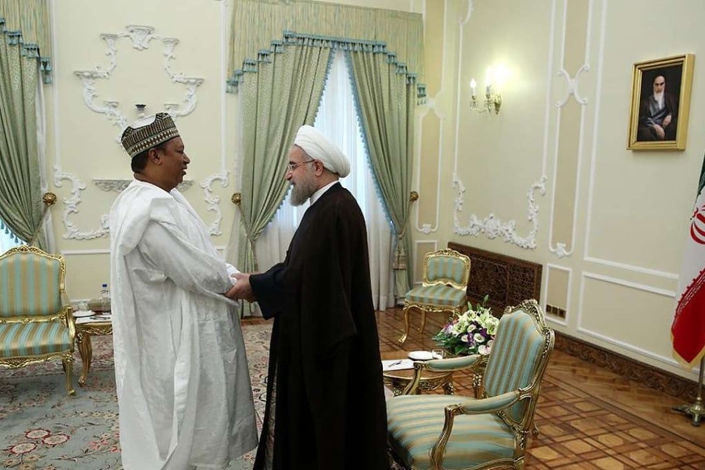 A handout picture made available by the presidential official website shows Iranian President Hassan Rouhani (R) greeting Secretary-General of the Organisation of Petroleum Exporting Countries (OPEC), Mohammed Barkindo (L) at the presidential office in Tehran, Iran. Photo: EPA