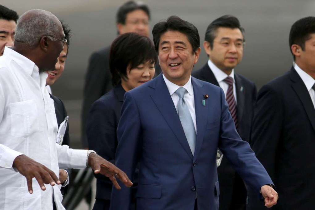 Japan’s Prime Minister Shinzo Abe (centre) talks to Salvador Antonio Valdes Mesa, member of the Political Bureau of the Central Committee of the Communist Party of Cuba and vice-president of the Council of State of Cuba upon his arrival at the Jose Marti International Airport in Havana, Cuba, on Wednesday. Photo: Reuters