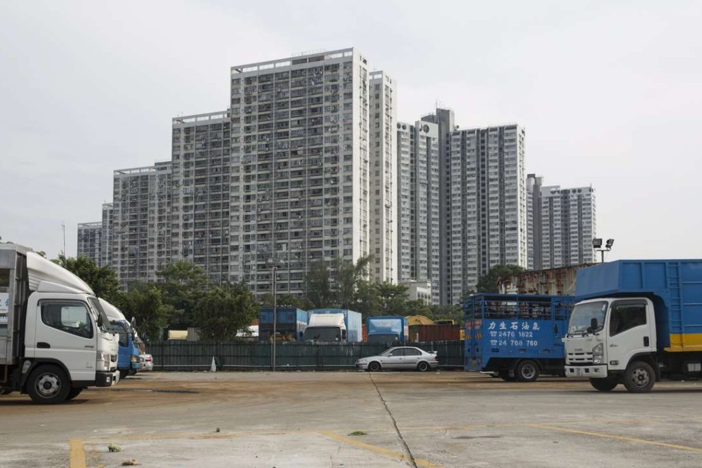 Trucks are parked on an illegally occupied government plot in Wang Chau, Yuen Long. Photo: EPA