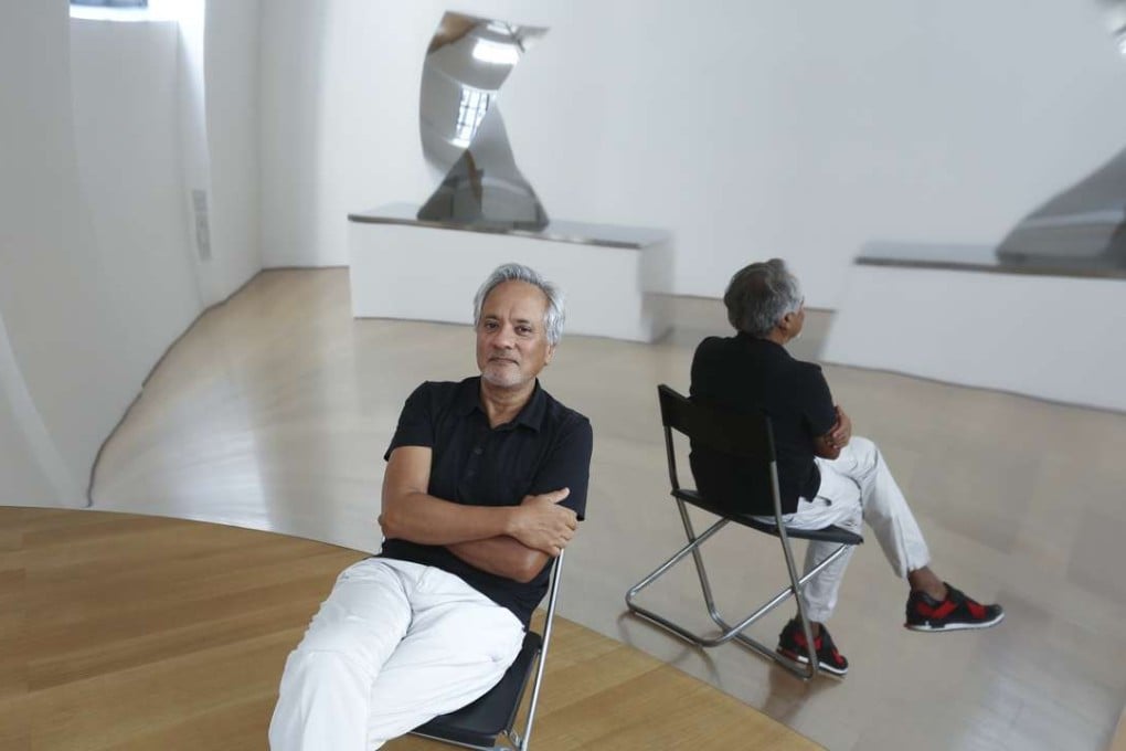 Anish Kapoor reflected in Vertigo, one of the works in his exhibition at the Gagosian Gallery, in Central. Picture: Jonathan Wong