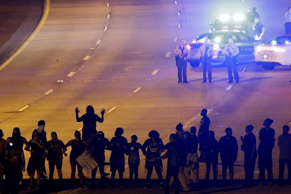 Protesters block a highway on Thursday in Charlotte, North Carolina, during a third night of unrest following Tuesday's police shooting of Keith Lamont Scott. Photo: AP