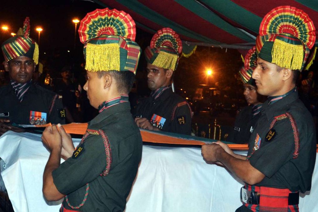An Indian army guard of honor carries the bodies of two soldiers killed in a terrorist attack on a base in Uri. Photo: NurPhoto