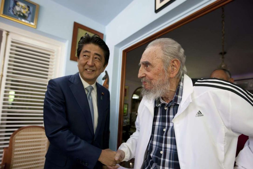 Cuba’s former leader Fidel Castro shakes hands with Japan's Prime Minister Shinzo Abe during a meeting in Havana. Photo: AP