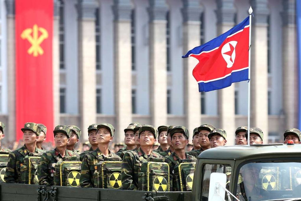 North Korean soldiers turn and look towards leader Kim Jong-un as they carry packs marked with the nuclear symbol during a parade marking the 60th anniversary of the Korean war armistice in Pyongyang. Photo: AP