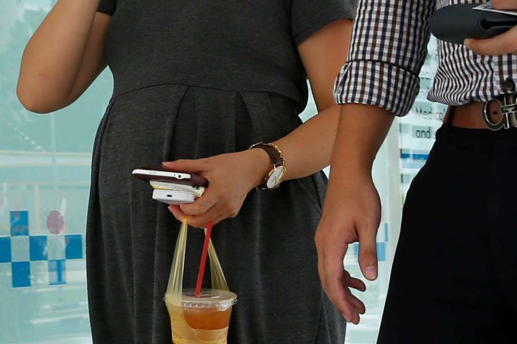 A pregnant couple walk together at a potential zika cluster in Singapore. Photo: Reuters
