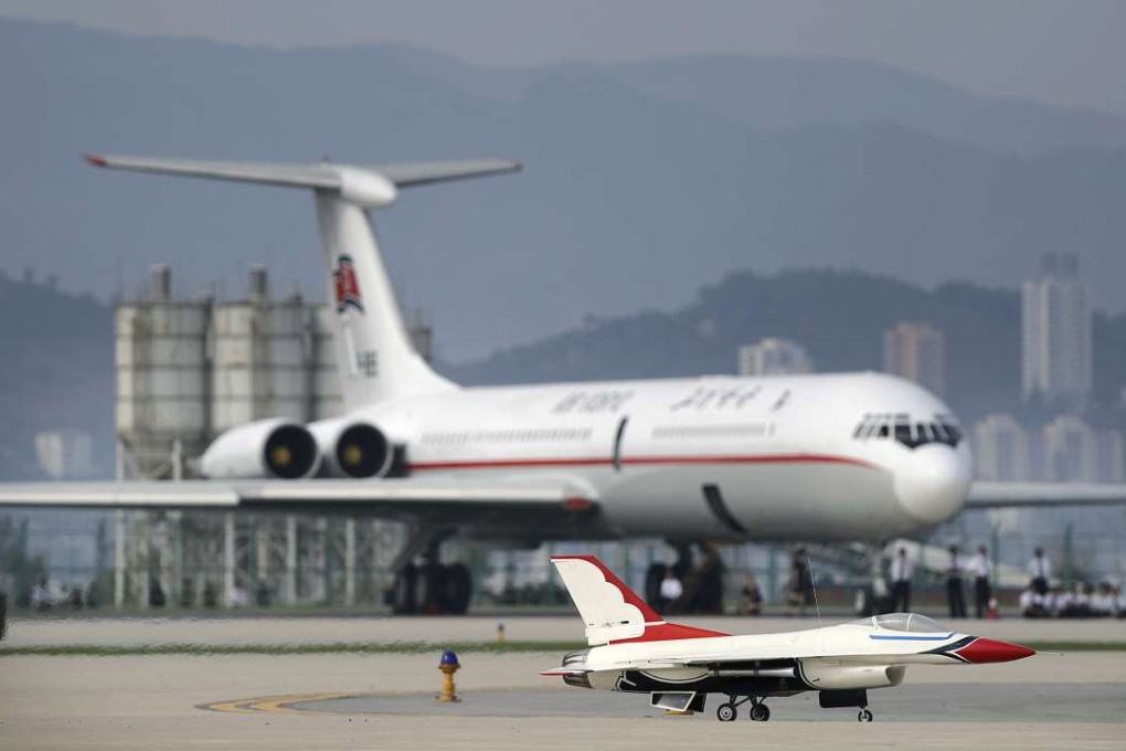 A remote-controlled F-16 fighter jet lands in front of an Air Koryo commercial aeroplane. Photo: AP