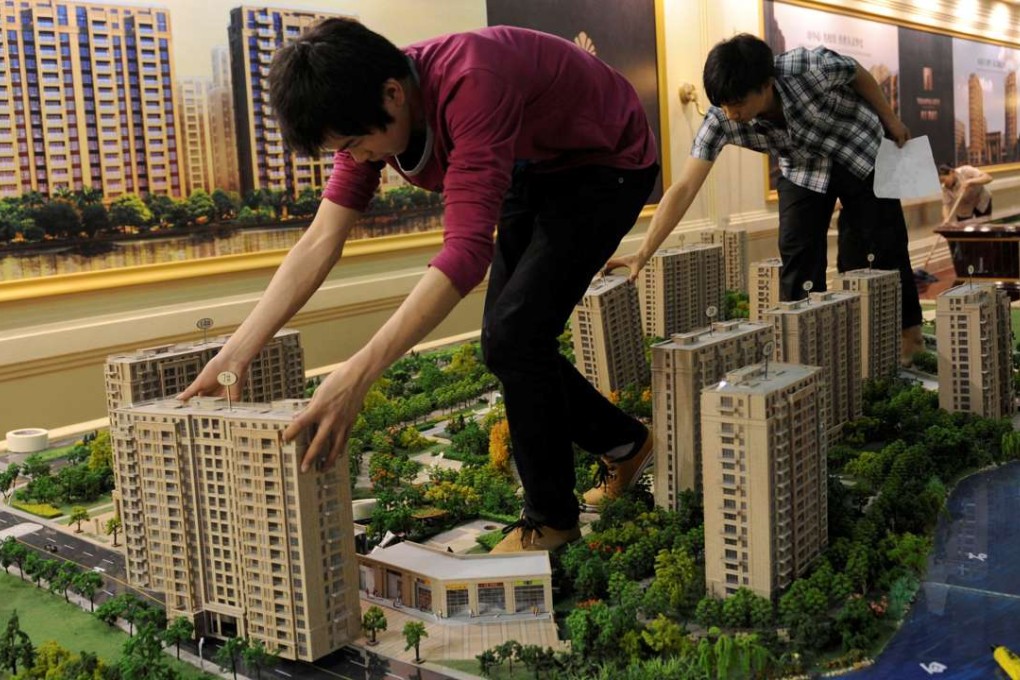 Employees set up model apartments as they prepare a real estate exhibition in Hangzhou in Zhejiang province. Photo: Reuters