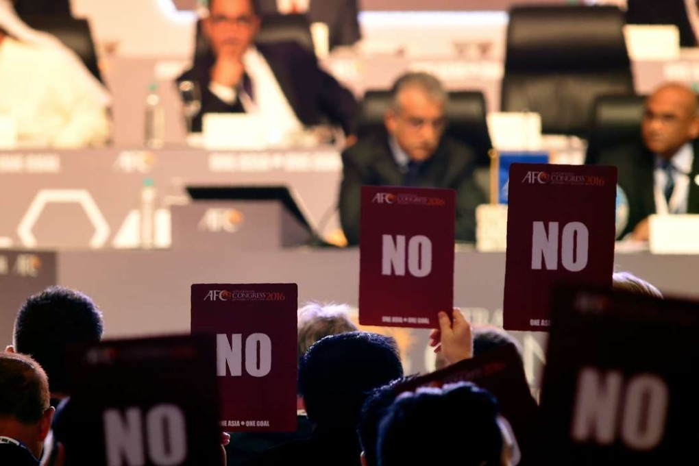 Members of the Asian Football Confederation hold up 'NO' voting cards during the AFC Extraordinary Congress in Goa. Photo: AFP