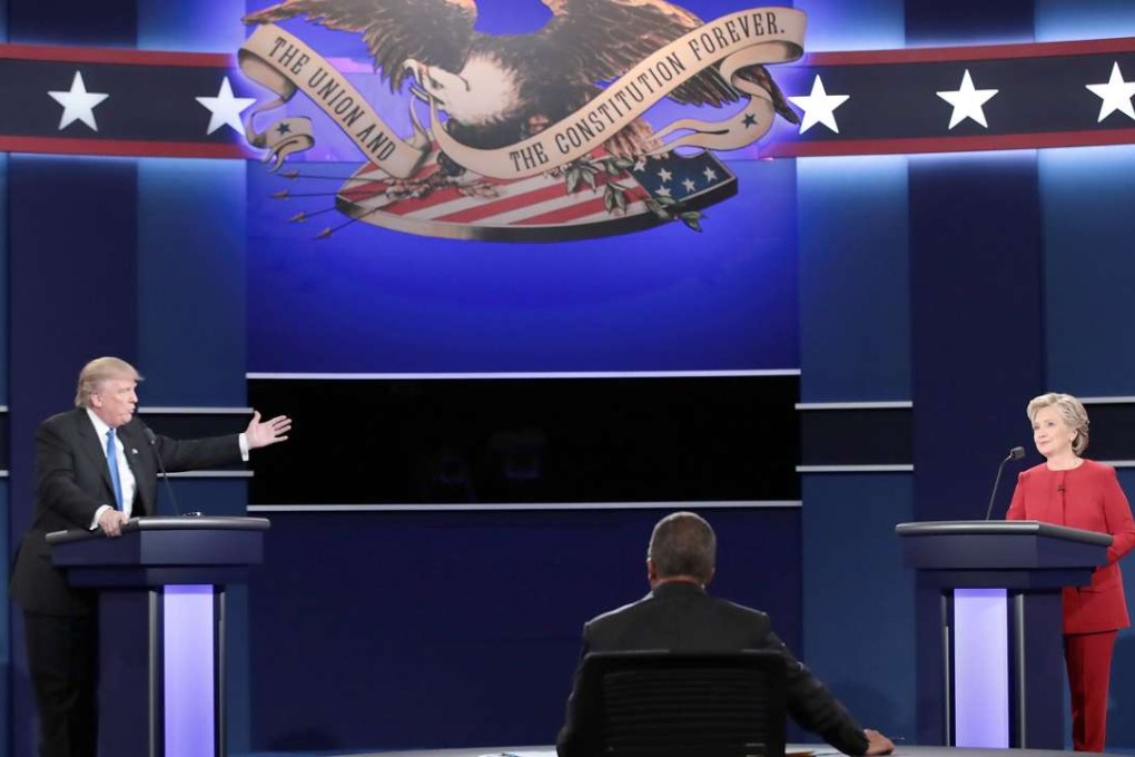 Republican presidential nominee Donald Trump (L) speaks as Democratic presidential nominee Hillary Clinton (R) listens during the Presidential Debate at Hofstra University. Photo: AFP