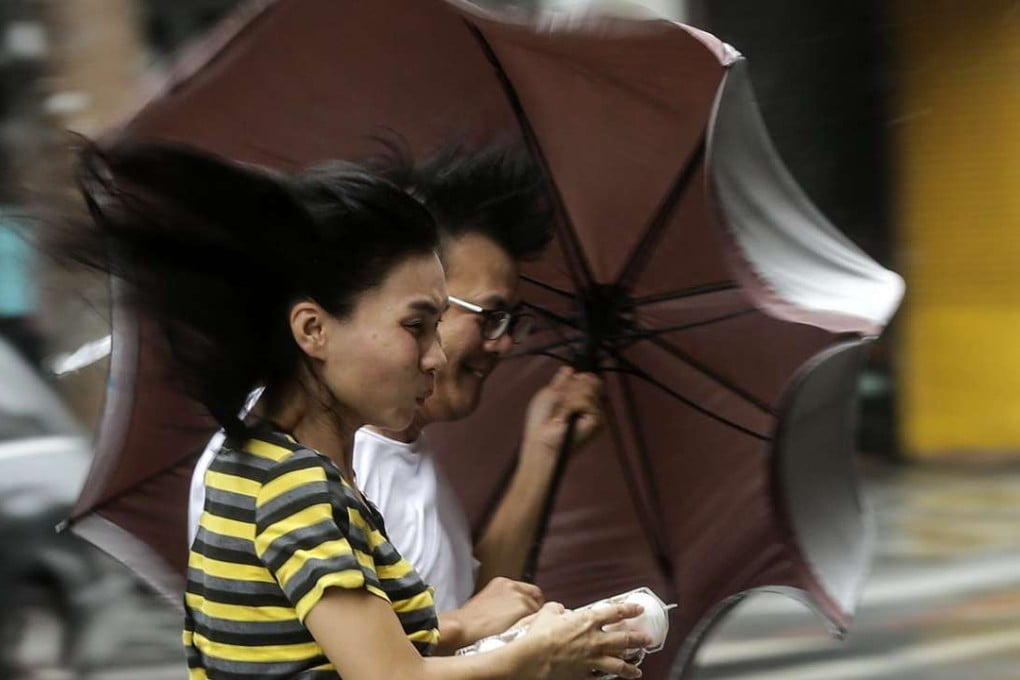 People brave heavy rains and strong winds as typhoon Megi hits Hualien county, in eastern Taiwan on Tuesday. Photo: EPA