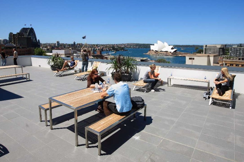 Travellers relaxing on the roof of a Youth Hostel Association hostel in Sydney. Photo: YHA