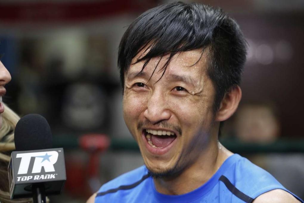 Zou Shiming smiles during a tv interview in June. (AP Photo/Mark Lennihan).