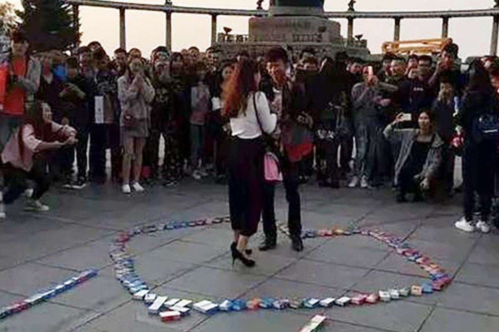 A crowd looks on as a man asks a young woman to be his girlfriend. Photo: SCMP Pictures