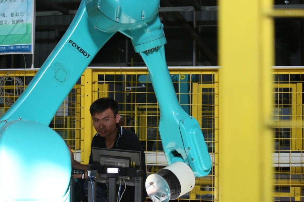 A Foxconn engineer tests a new industrial robot at the company’s factory in Longhua town, Shenzhen. The city has quickly developed into China’s leading technology hub, but challenges loom. Photo: Nora Tam