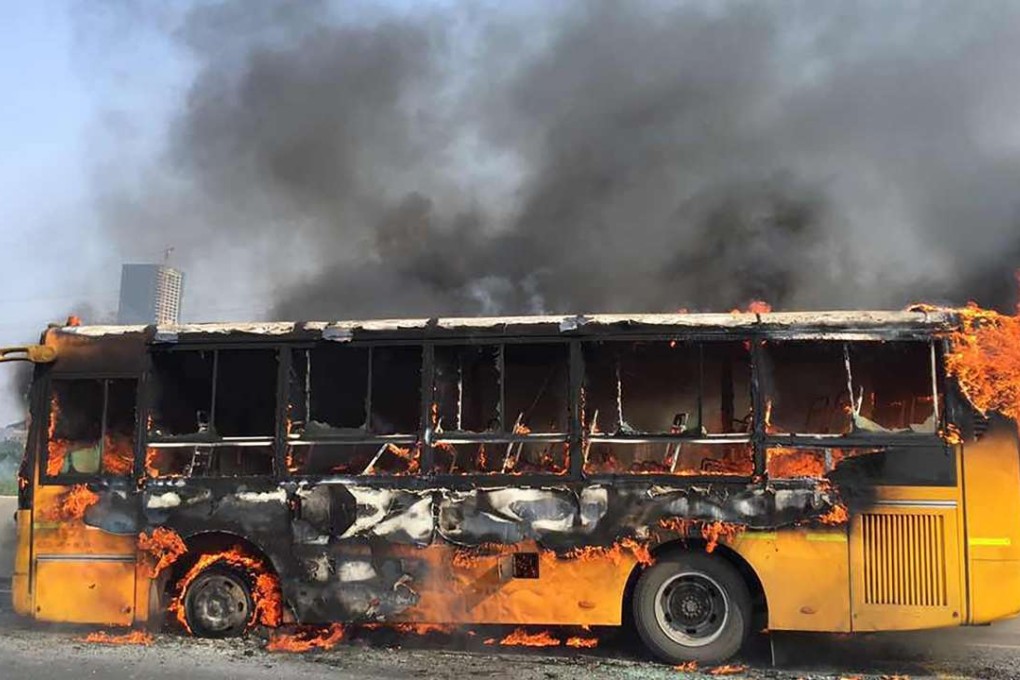 The evacuated school bus , which eventually burned down to its frame. Photo: SCMP Pictures
