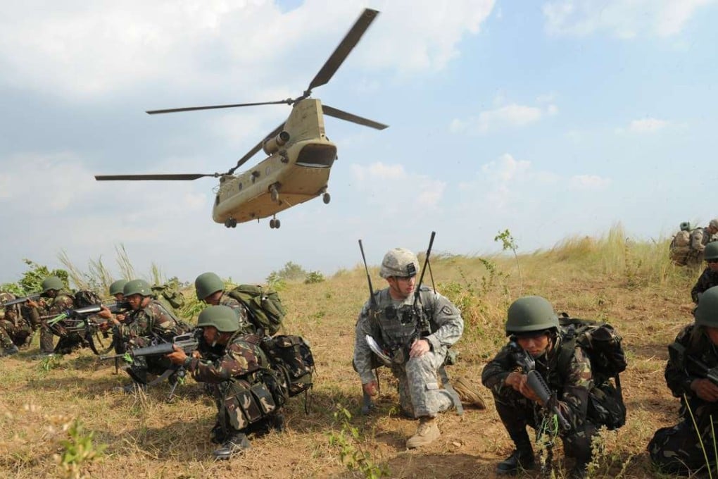 Philippine soldiers and a US army soldier take their positions after disembarking from a C-47 Chinook helicopter during an air assault exercise in Nueva Ecija province north of Manila in April last year. Philippines President Rodrigo Duterte said on Wednesdat he will soon end joint military exercises with the United States. Photo: AFP