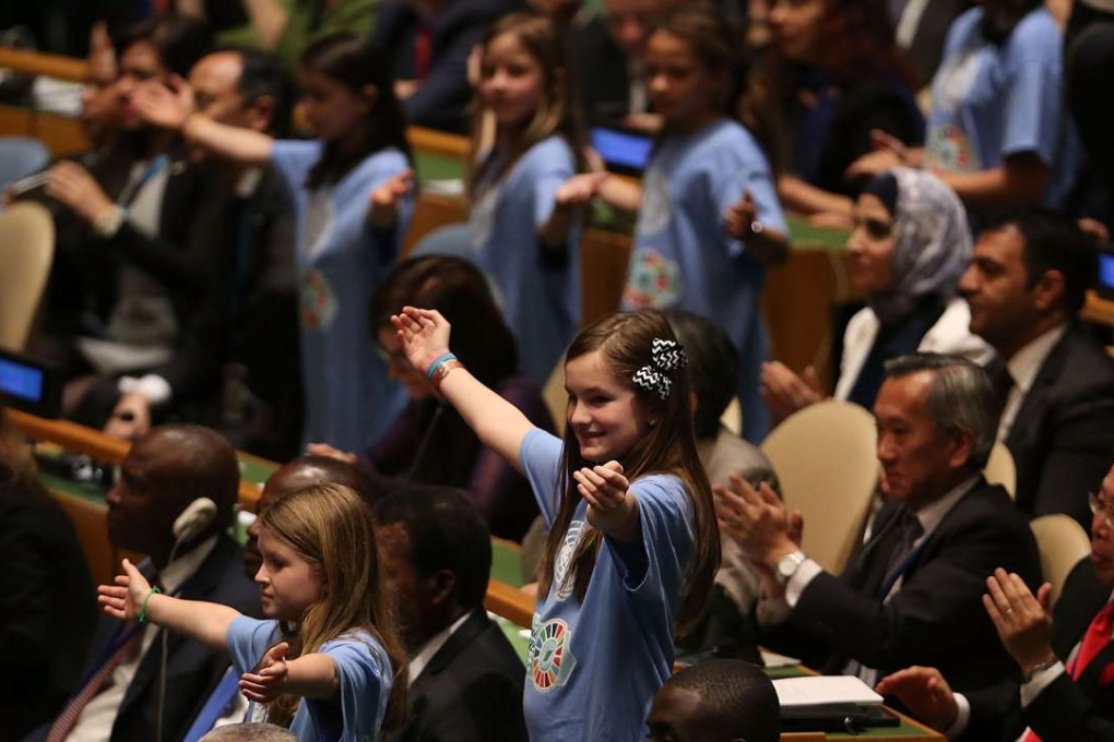 Children from around the world stand with leaders and country delegates in the General Assembly Hall at the UN signing ceremony for the Paris Agreement on April 22 in New York City. Photo: AFP