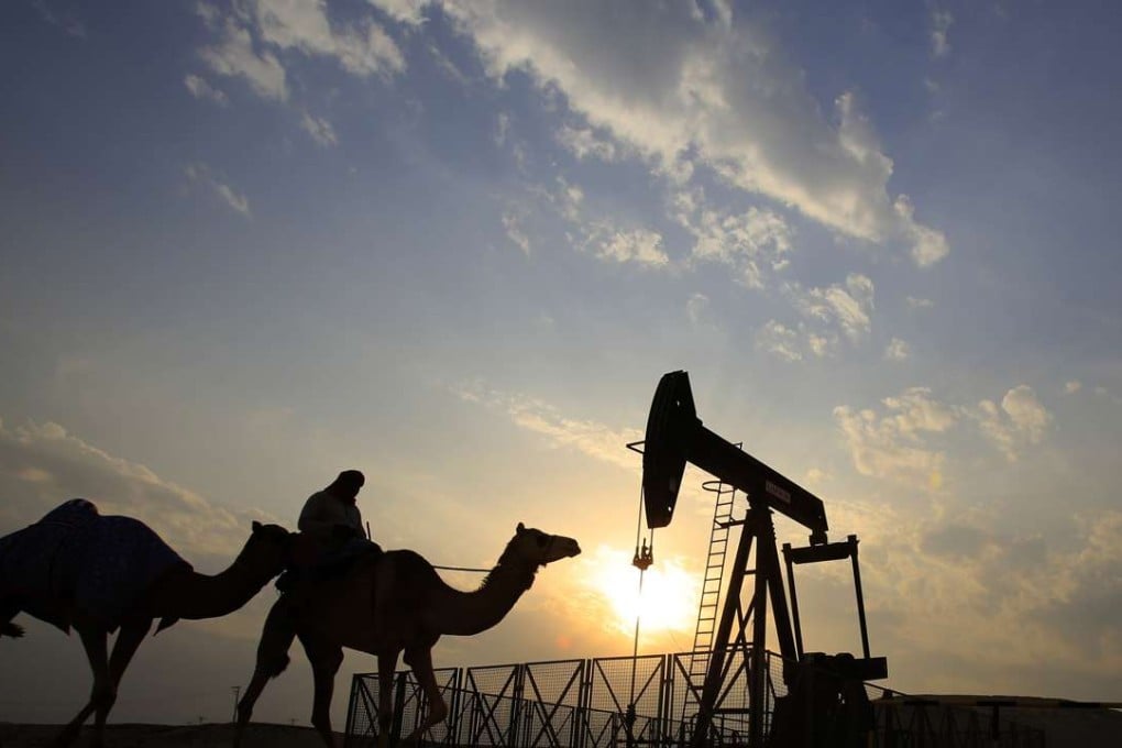 A man rides a camel through the desert oil field and winter camping area of Sakhir, Bahrain. OPEC nations have agreed in theory that they need to reduce their production to help boost global oil prices. Photo: AP