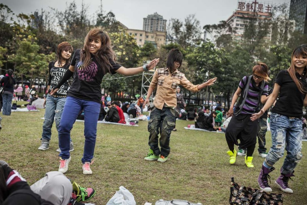 An Indonesian dance group practises on the lawn of Victoria Park in Causeway Bay. Many of Hong Kong’s domestic workers hail from Indonesia. Photo: SCMP Pictures