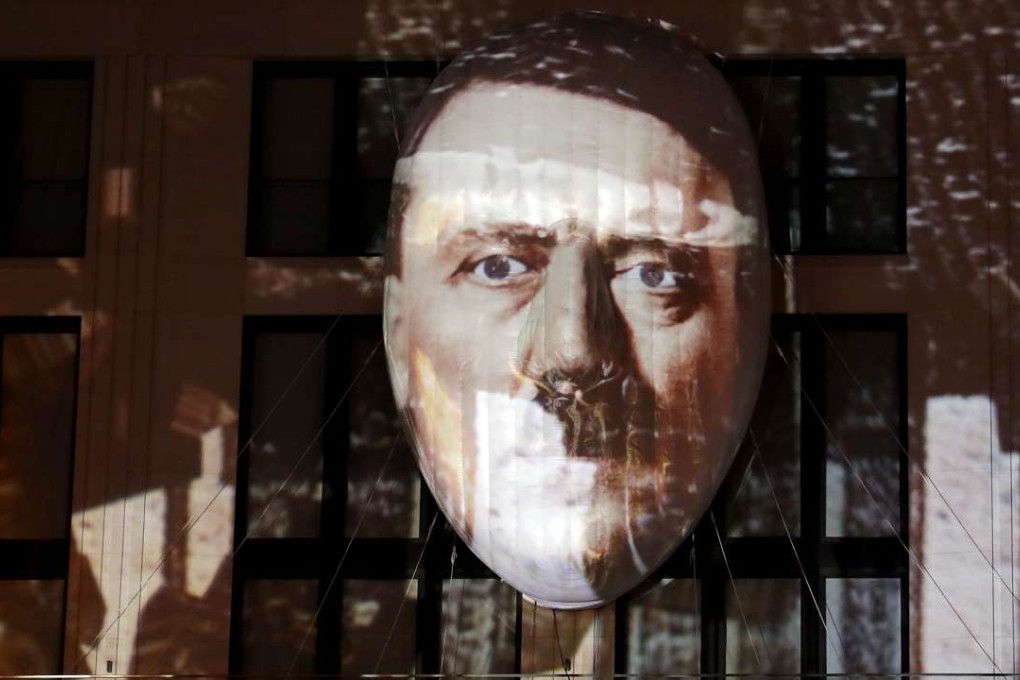 The face of Adolf Hitler is projected onto a 3D canvas as part of an art installation during a rehearsal for the 'Berlin Leuchtet' (Berlin shines) festival in Berlin, Germany. Photo: AP