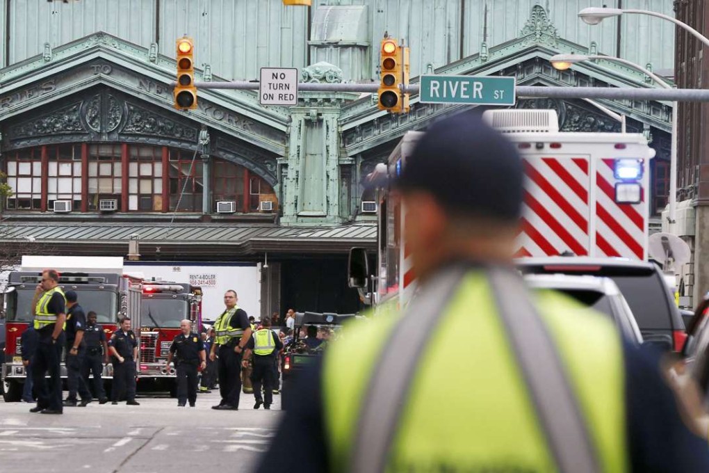 Hoboken police officers look over the scene of the train crash in Hoboken. Photo: Reuters