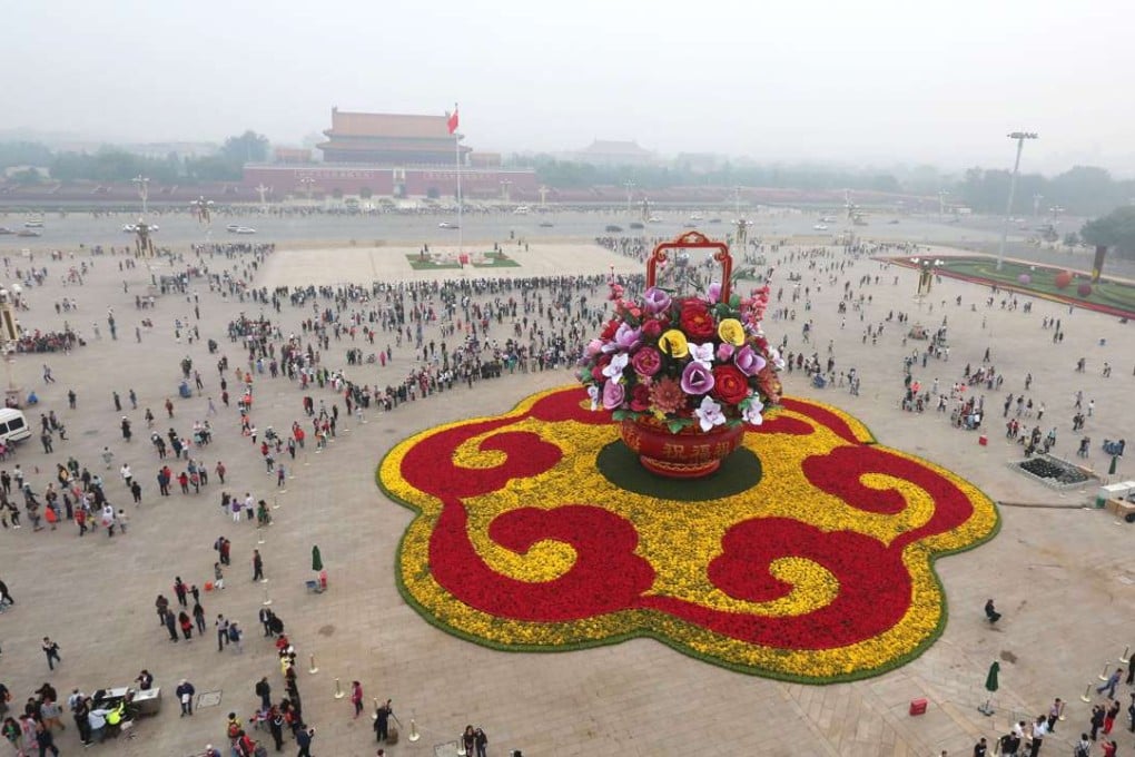 Smog hovers above Tiananmen Square in central Beijing, decorated with floral decorations on Sunday to mark the National Day holiday, which begins on Saturday. Photo: Xinhua
