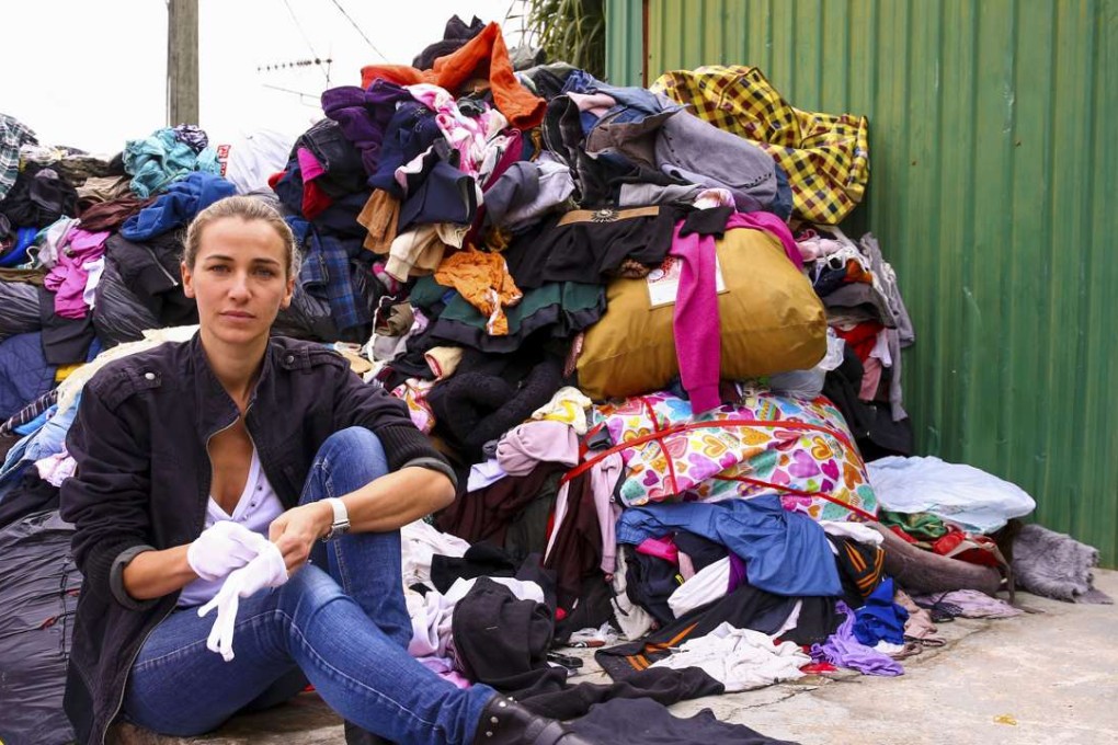 Redress founder Christina Dean with discarded clothing waiting to be turned into modern, wearable pieces.