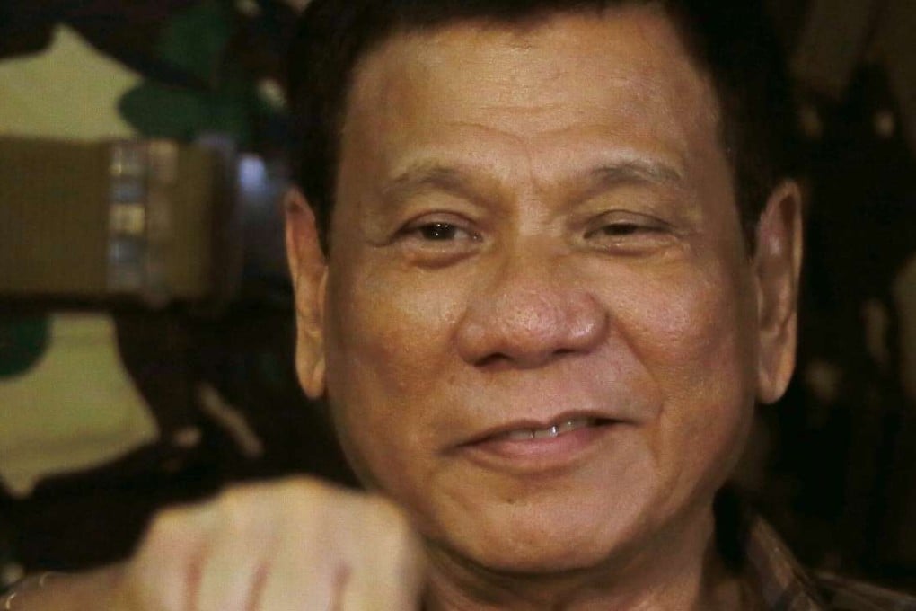 Philippine President Rodrigo Duterte gestures with a fist bump during his visit to the Philippine Army's Camp Mateo Capinpin at Tanay township. Photo: AP